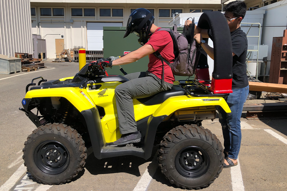 A scientist test a rollover protection bar on an all-terrain vehicle