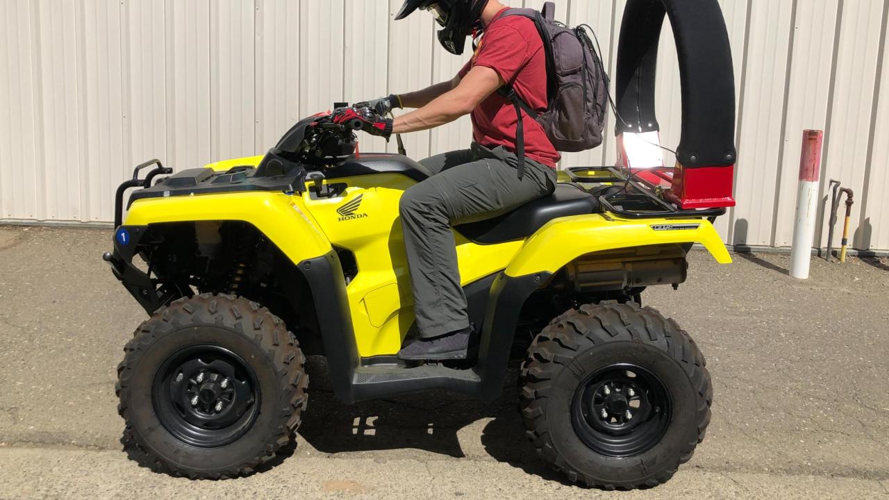 An all-terrain vehicle with a roll bar attached to the back